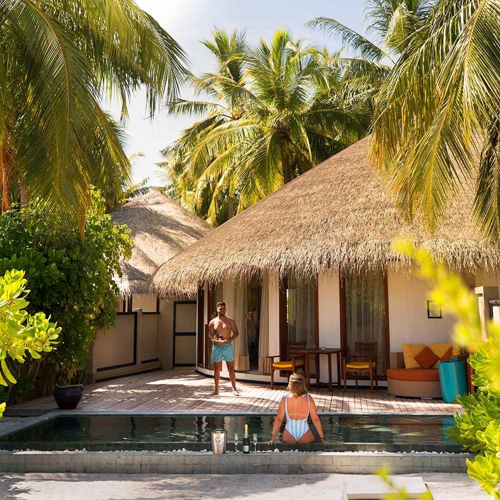 Couple enjoying the pool in their villa at Angsana Velavaru, a 5 star resort in the Maldives