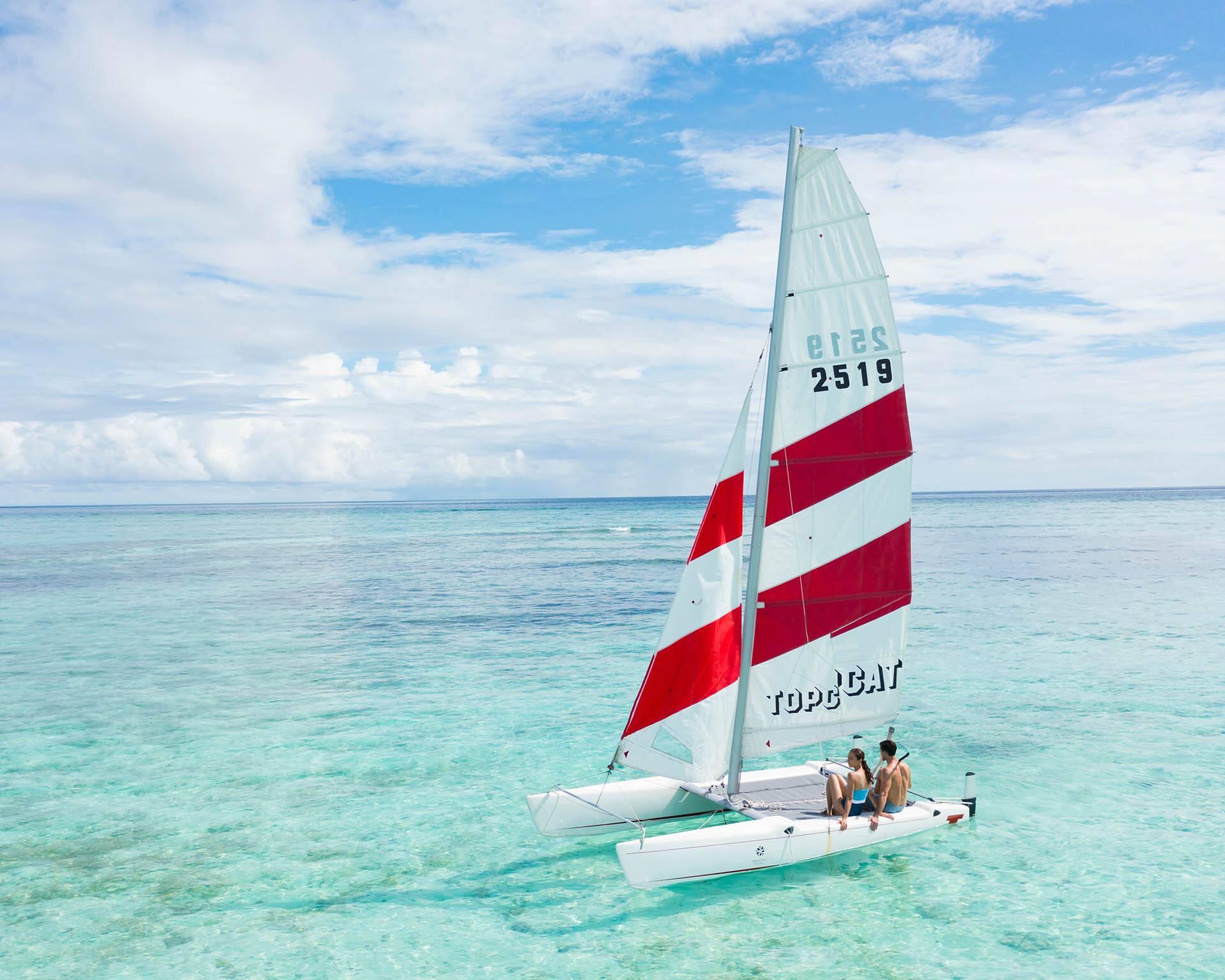 Unforgettable love story in the Maldives: A honeymoon couple embraces paradise at Angsana Velavaru, their love reflected in the endless ocean and luxurious surrounds.