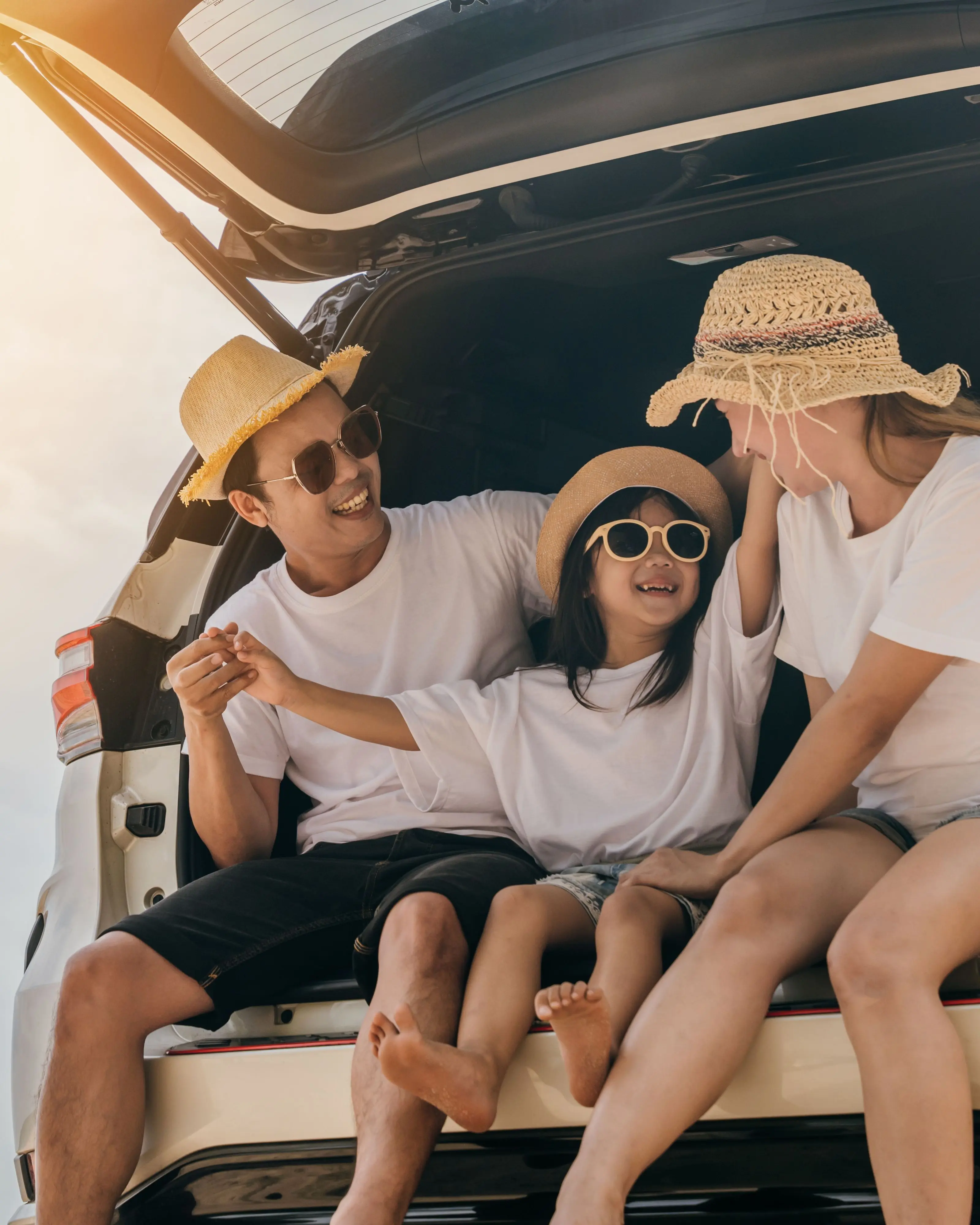 image of asian family on the back of the car going for a road trip, family roadtrip, family vacation, school holidays